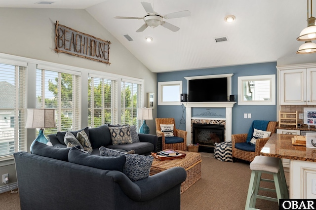 747 Hammock Ln Lot 55, Corolla, NC 27927 - living area with carpet floors, healthy amount of natural light, a ceiling fan, a fireplace, and high vaulted ceiling