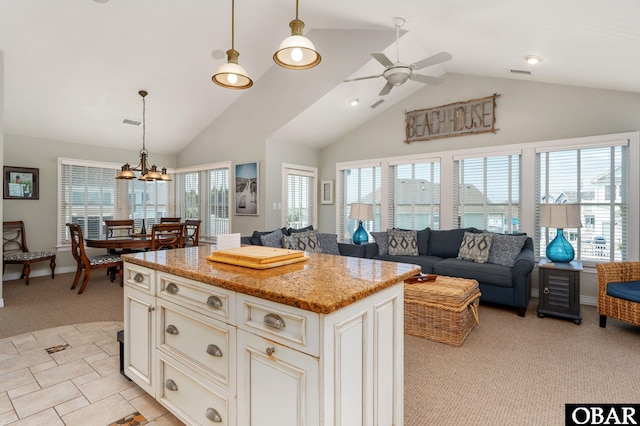 747 Hammock Ln Lot 55, Corolla, NC 27927 - kitchen featuring light carpet, a ceiling fan, plenty of natural light, light stone countertops, and high vaulted ceiling