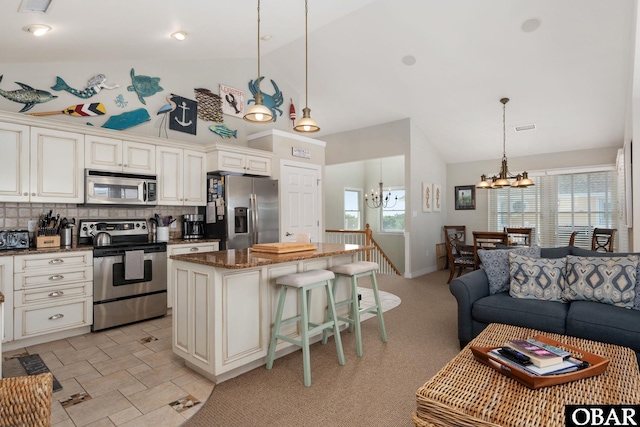 747 Hammock Ln Lot 55, Corolla, NC 27927 - kitchen featuring appliances with stainless steel finishes, a chandelier, high vaulted ceiling, a center island, and tasteful backsplash