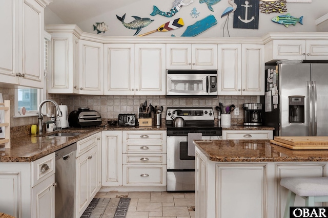 747 Hammock Ln Lot 55, Corolla, NC 27927 - kitchen with appliances with stainless steel finishes, backsplash, and dark stone countertops