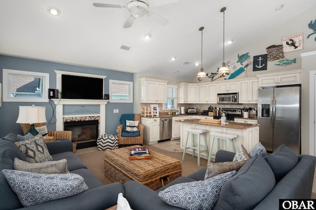 747 Hammock Ln Lot 55, Corolla, NC 27927 - living area featuring lofted ceiling, ceiling fan, a glass covered fireplace, and recessed lighting