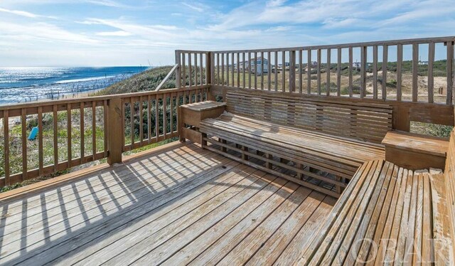 deck featuring a water view and a view of the beach