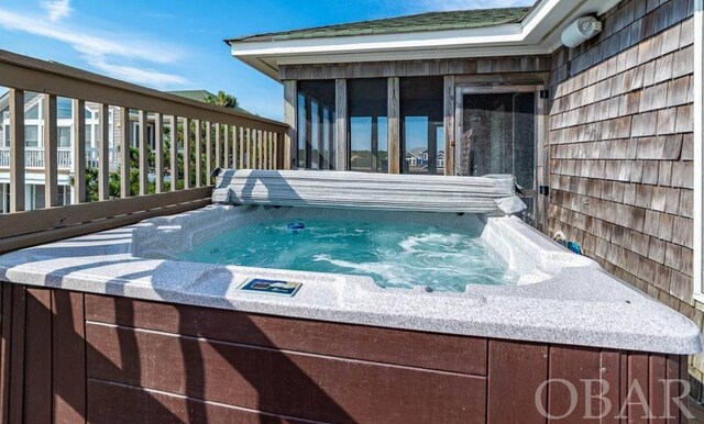 wooden terrace with a hot tub