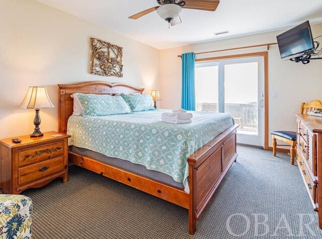 bedroom with access to exterior, ceiling fan, visible vents, and dark colored carpet