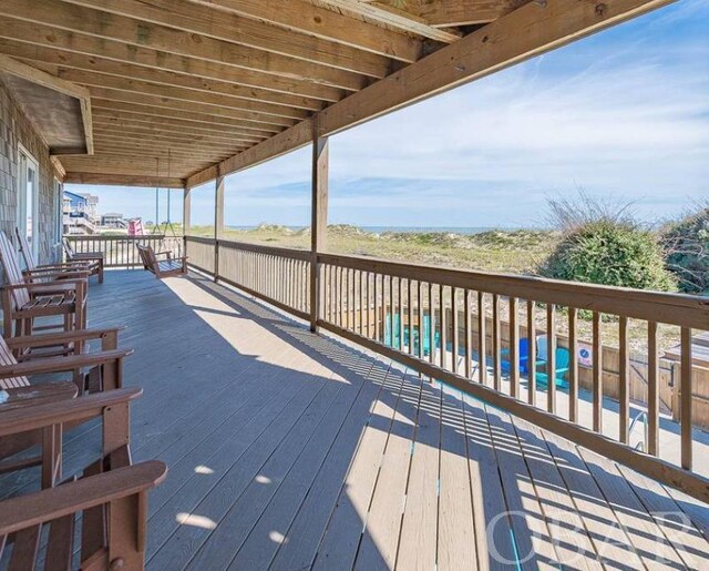 deck featuring a pool and fence