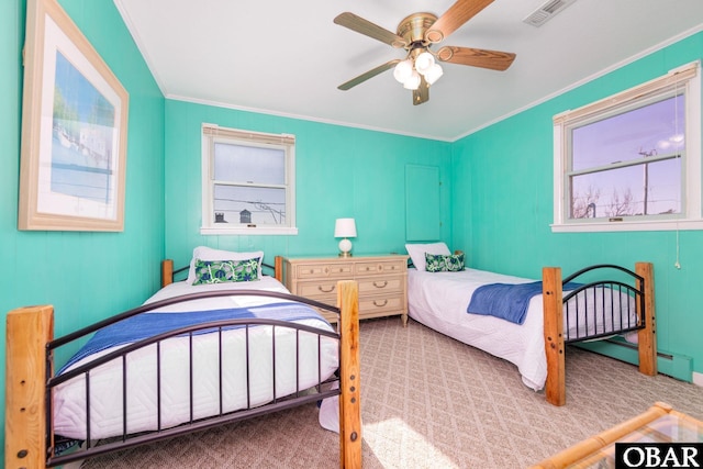 bedroom featuring a ceiling fan, visible vents, crown molding, and carpet flooring