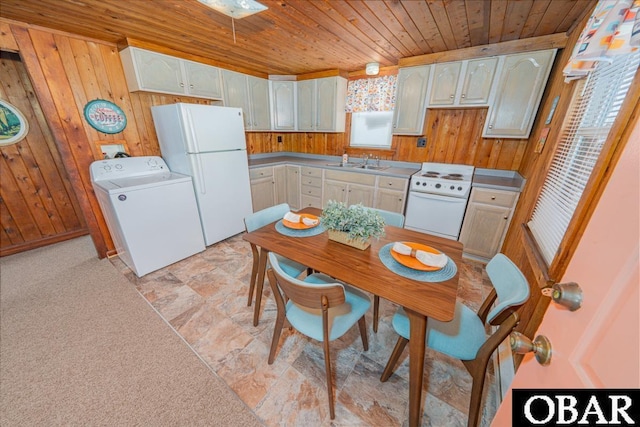 105 Rocky Mount St Lot 399, Kill Devil Hills, NC 27949 - kitchen featuring washer / clothes dryer, wood ceiling, wooden walls, and white appliances