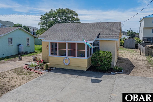 105 Rocky Mount St Lot 399, Kill Devil Hills, NC 27949 - view of front of house featuring a shingled roof and a storage unit