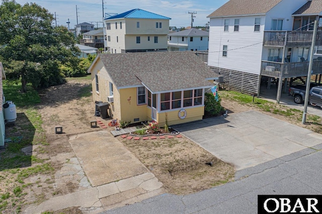 105 Rocky Mount St Lot 399, Kill Devil Hills, NC 27949 - view of front of house featuring a shingled roof, a residential view, and concrete driveway