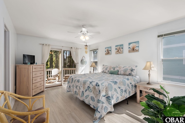 bedroom with access to outside, light wood-style flooring, and a ceiling fan