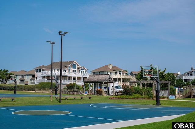 view of sport court featuring a yard and community basketball court