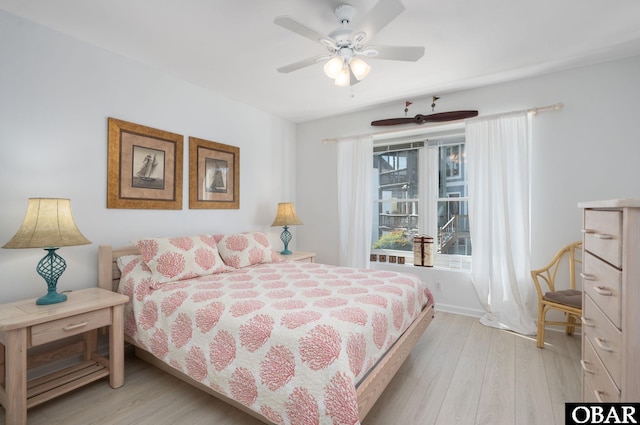 bedroom featuring a ceiling fan, baseboards, and light wood finished floors