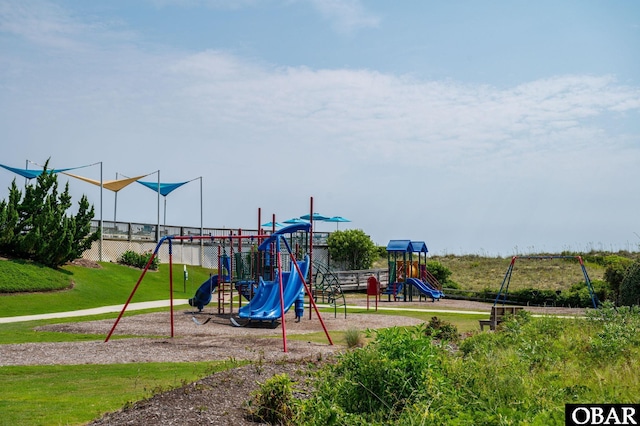 community jungle gym with a yard