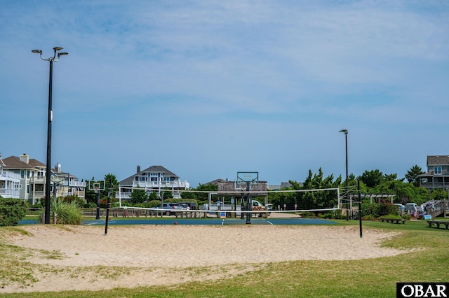 view of home's community with a yard and volleyball court