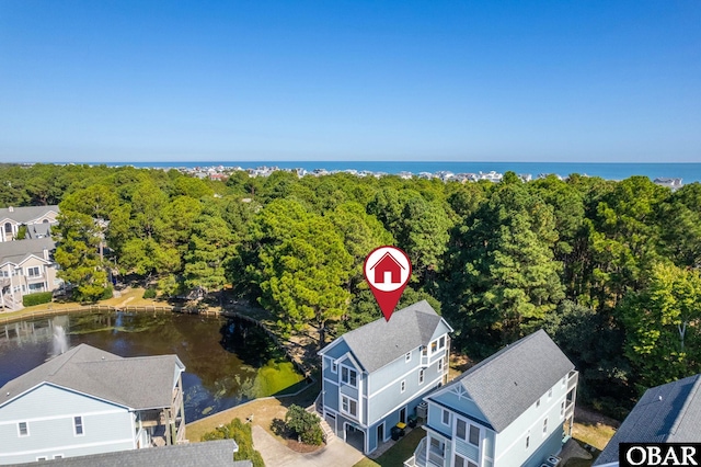 aerial view featuring a water view, a forest view, and a residential view