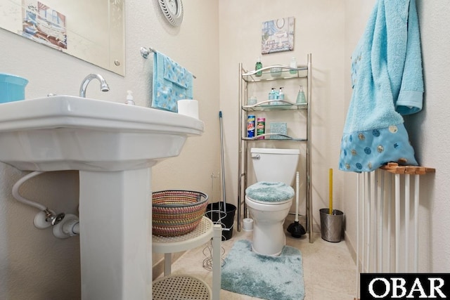 bathroom featuring toilet and tile patterned floors