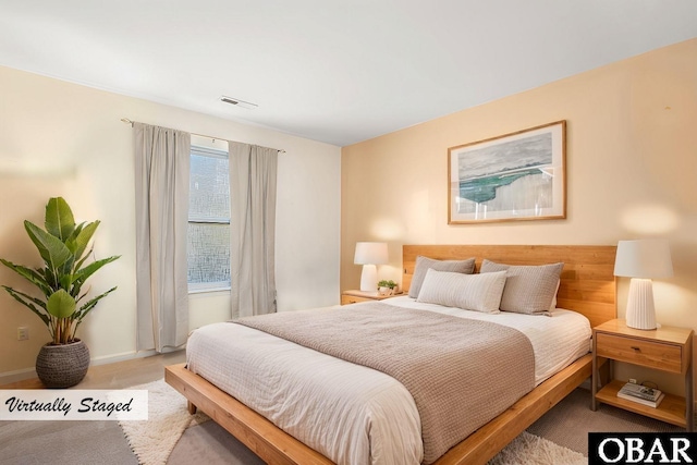 carpeted bedroom with baseboards and visible vents