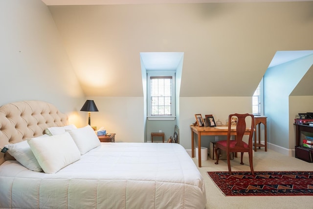 bedroom featuring vaulted ceiling, carpet, and baseboards