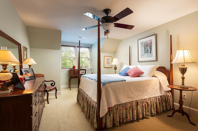 bedroom with visible vents, baseboards, light colored carpet, ceiling fan, and vaulted ceiling