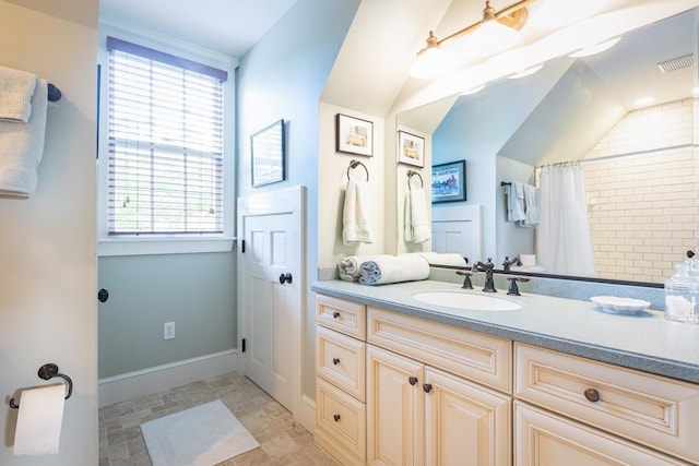 bathroom with visible vents, a shower with curtain, baseboards, lofted ceiling, and vanity