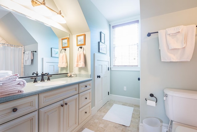 bathroom featuring vanity, toilet, and baseboards