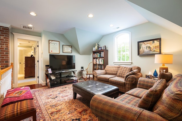 living area featuring recessed lighting, visible vents, and lofted ceiling