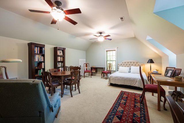 bedroom with vaulted ceiling, light colored carpet, visible vents, and ceiling fan