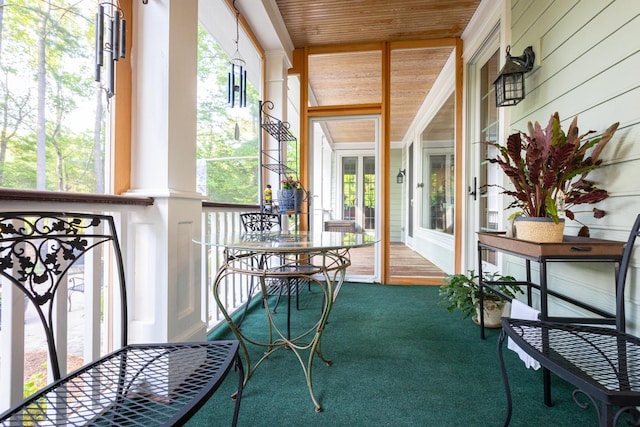 sunroom / solarium featuring wood ceiling