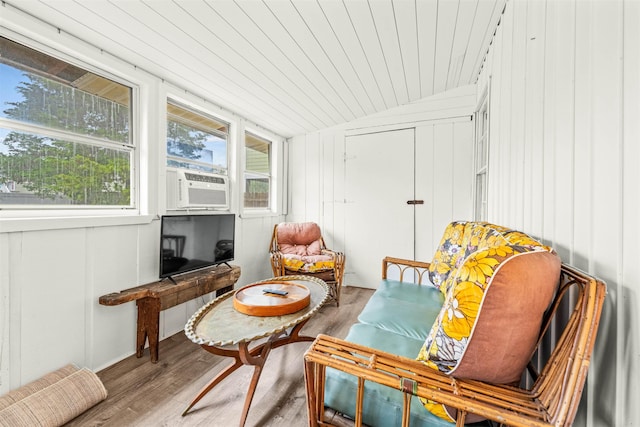 living area with cooling unit, wood ceiling, vaulted ceiling, and wood finished floors