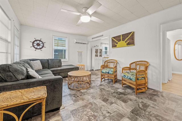 living area featuring a wall unit AC and ceiling fan