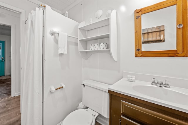 bathroom featuring toilet, wood finished floors, and vanity