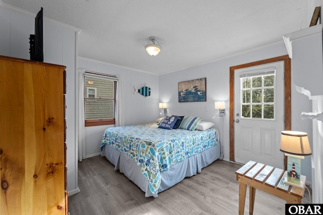 1400 N Virginia Dare Trl, Kill Devil Hills, NC 27948 - bedroom featuring ornamental molding and light wood-type flooring