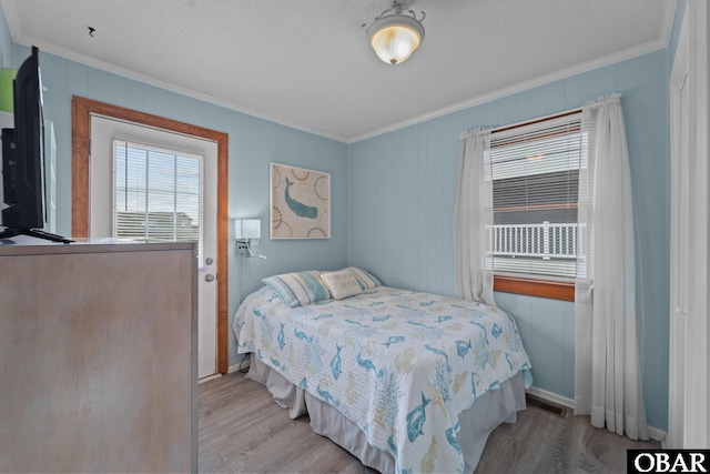 1400 N Virginia Dare Trl, Kill Devil Hills, NC 27948 - bedroom with crown molding, wood finished floors, and baseboards