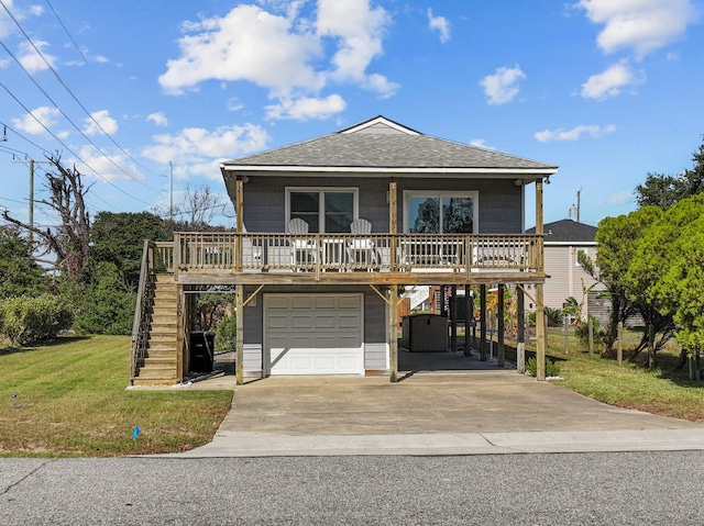 view of front of house with roof with shingles, concrete driveway, stairway, a garage, and a front lawn