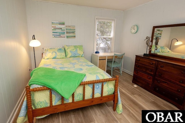 bedroom with baseboards and wood finished floors