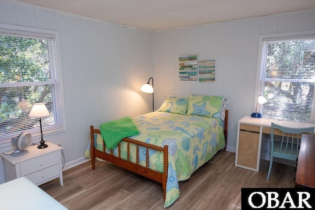 bedroom with baseboards and wood finished floors