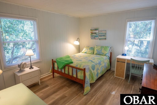 bedroom featuring baseboards and wood finished floors