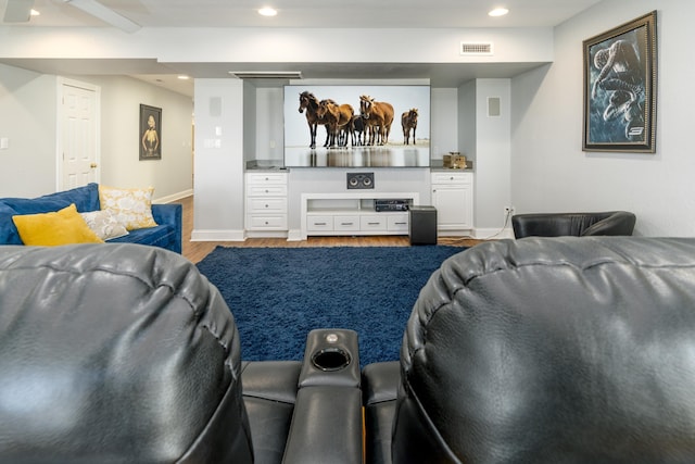 home theater featuring recessed lighting, visible vents, baseboards, and wood finished floors