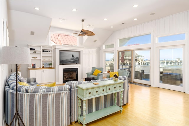 living area with visible vents, a fireplace, recessed lighting, ceiling fan, and light wood-style floors