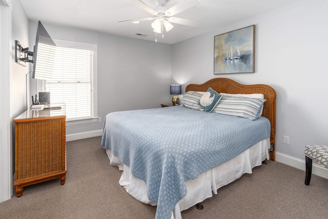 carpeted bedroom with visible vents, a ceiling fan, and baseboards