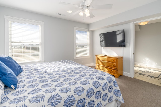 bedroom with visible vents, ceiling fan, carpet, and baseboards