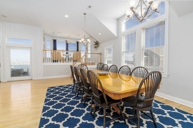 dining room with light wood-style flooring, a notable chandelier, recessed lighting, and baseboards