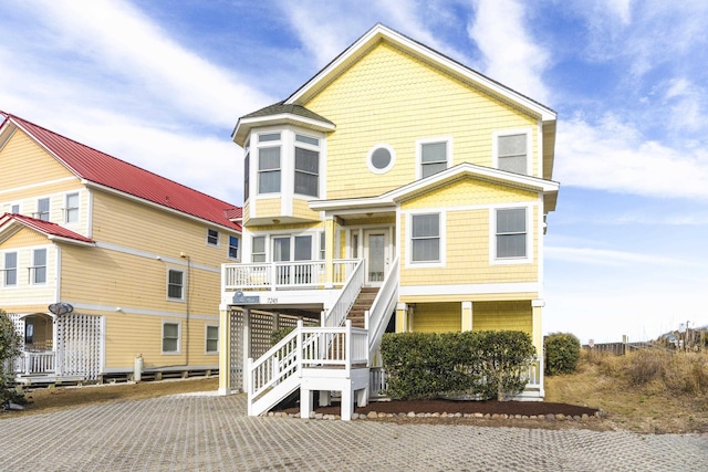 raised beach house with stairway and covered porch