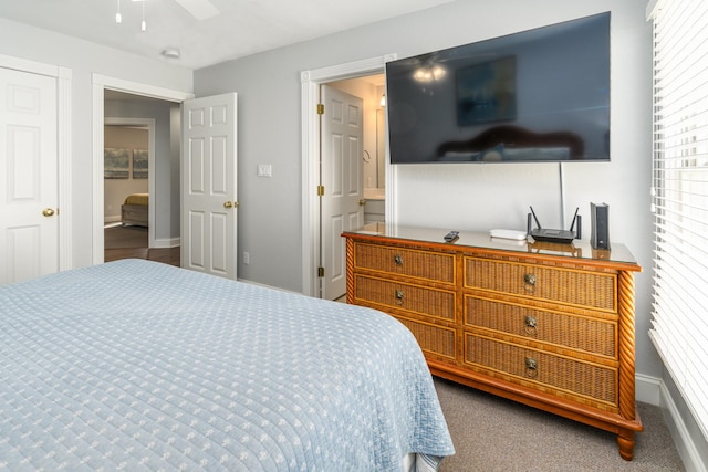 carpeted bedroom with multiple windows, connected bathroom, and baseboards