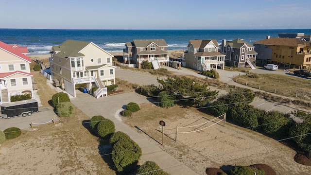 drone / aerial view featuring a residential view and a water view