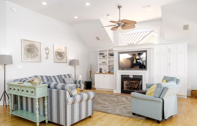 living area with recessed lighting, a fireplace, light wood-style floors, high vaulted ceiling, and a ceiling fan