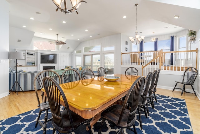 dining room featuring recessed lighting, light wood-style flooring, a fireplace, and baseboards