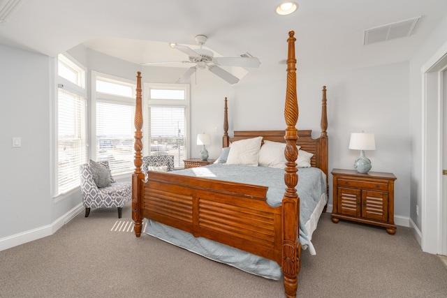 carpeted bedroom with visible vents, multiple windows, a ceiling fan, and baseboards