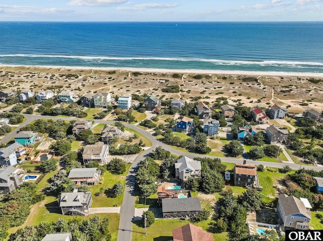 drone / aerial view with a water view and a beach view