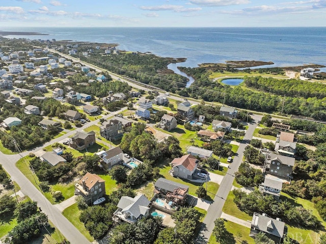 drone / aerial view with a water view and a residential view